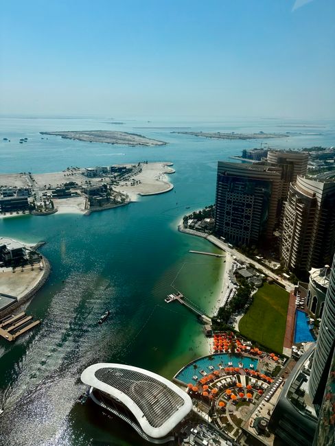 Stunning aerial view of Dubai Marina, the Persian Gulf, and the Palm Islands on a sunny day.